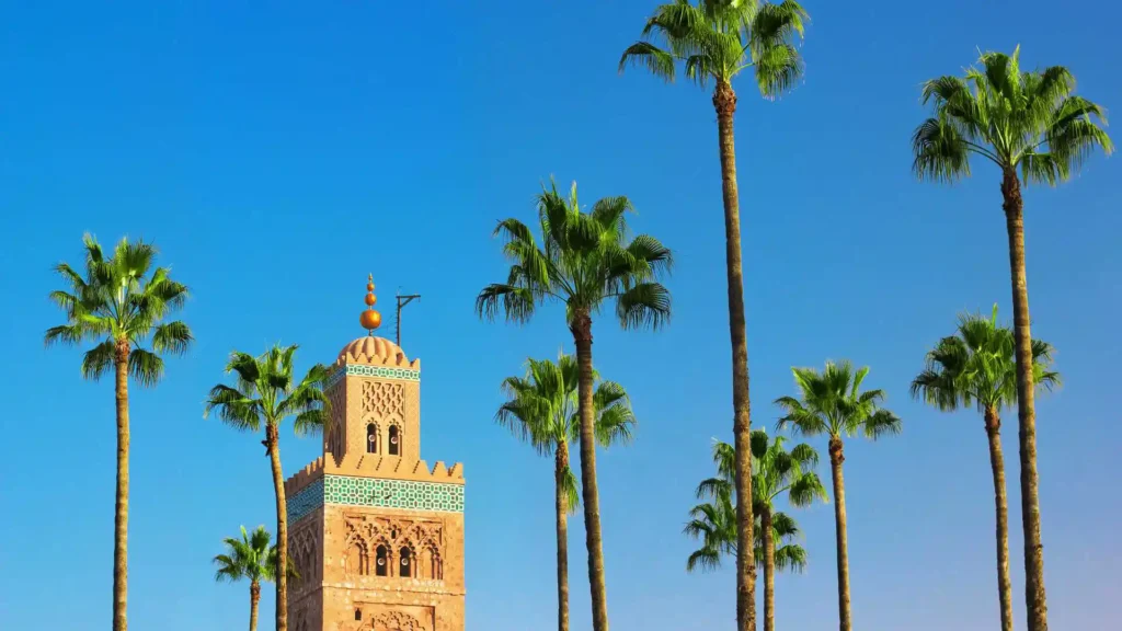 Marrakech Travel Guide 2026 – Koutoubia Mosque with palm trees under blue sky