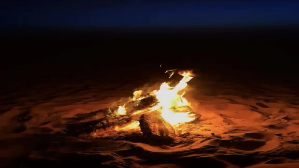 Campfire burning in the Sahara at night in the Chegaga Desert after a long journey from Marrakech