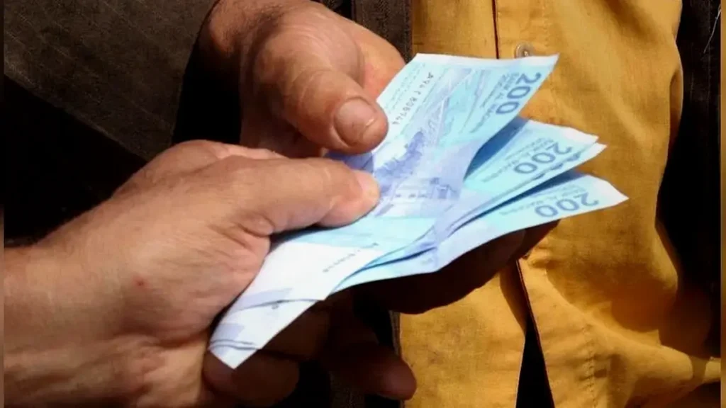 Cash payment in a Marrakech souk with Moroccan handmade goods