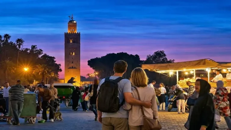 Is Marrakech safe for tourists -Tourist couple walking in Jemaa el-Fna square at evening in Marrakech