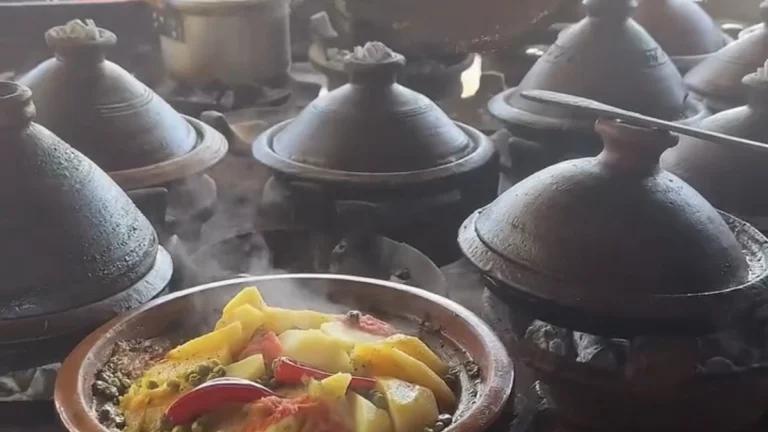 Traditional Moroccan tagine cooking at a local food stall in Morocco