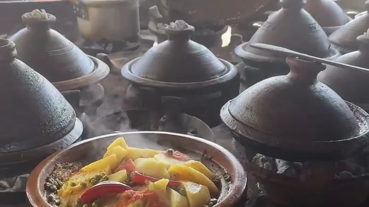 Traditional Moroccan tagine cooking at a local food stall in Morocco