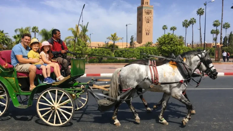 Family enjoying a horse carriage ride in Marrakech with kids near Koutoubia Mosque