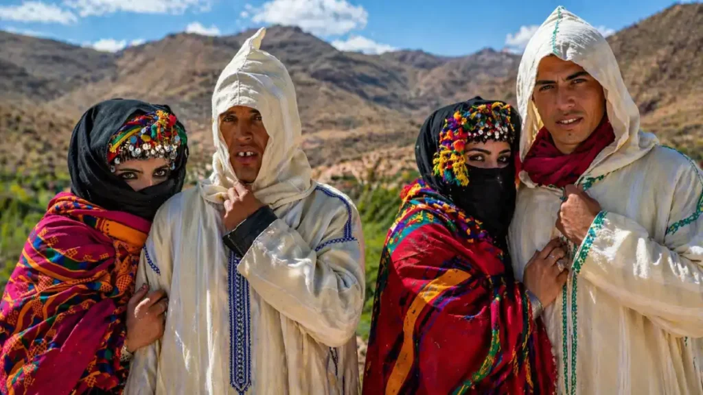 Imilchil Marriage Festival Morocco two Amazigh couples in traditional clothing posing in the Atlas Mountains during a colorful local cultural celebration
