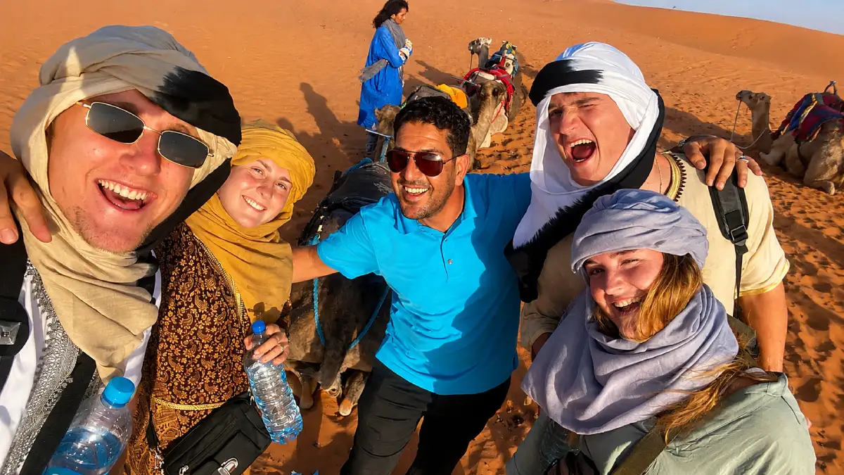 Kamal with travelers on a Sahara Desert tour in Morocco