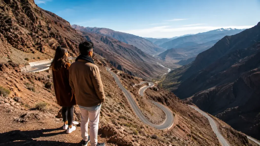 Travelers overlooking a winding Atlas Mountains road during a Morocco February itinerary