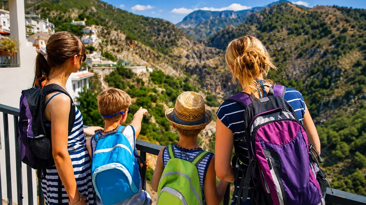 Family with backpacks overlooking a mountain valley in Morocco