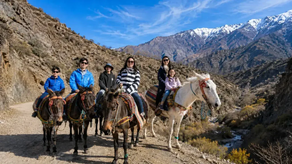 Family riding mules in the Atlas Mountains in Morocco
