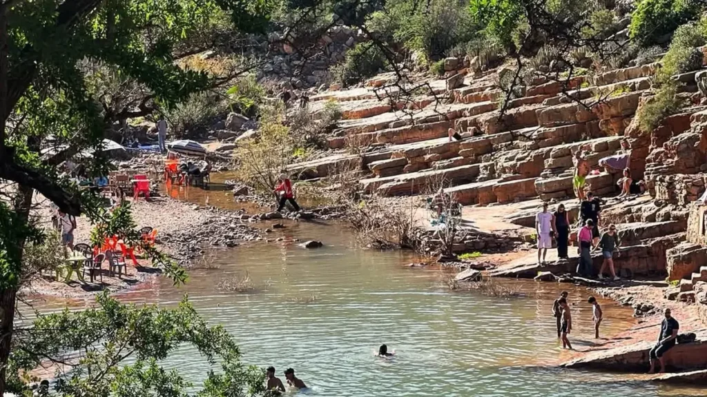 Visitors swimming in a natural pool at Paradise Valley Morocco