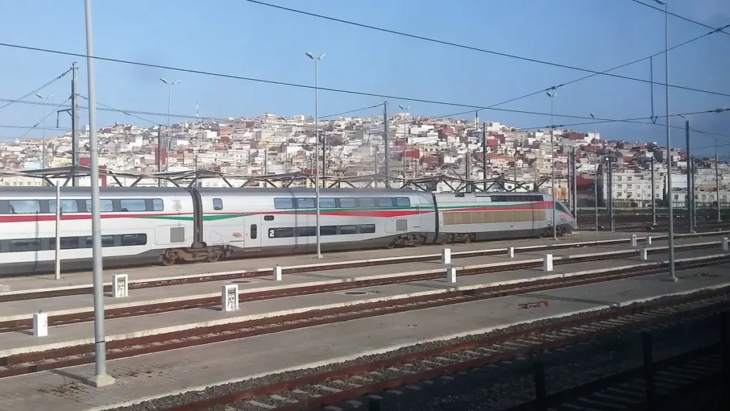 Al Boraq train on railway tracks with Tangier buildings behind it