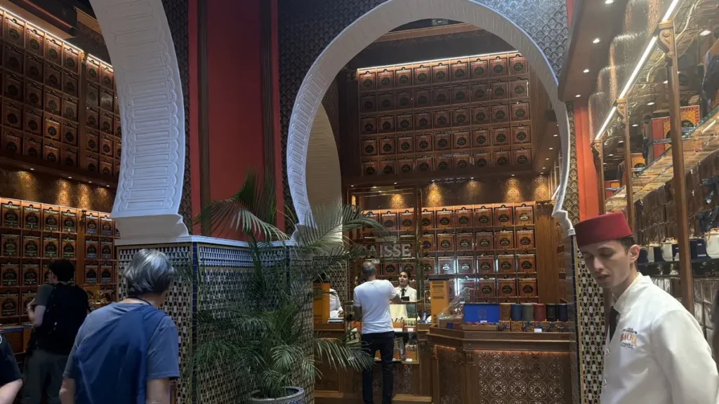 Bacha Coffee boutique with arched doorways, tiled columns and shelves of packaged coffee