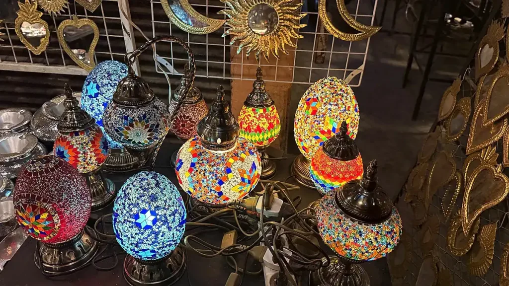 Colourful mosaic glass table lamps illuminated on a shop display