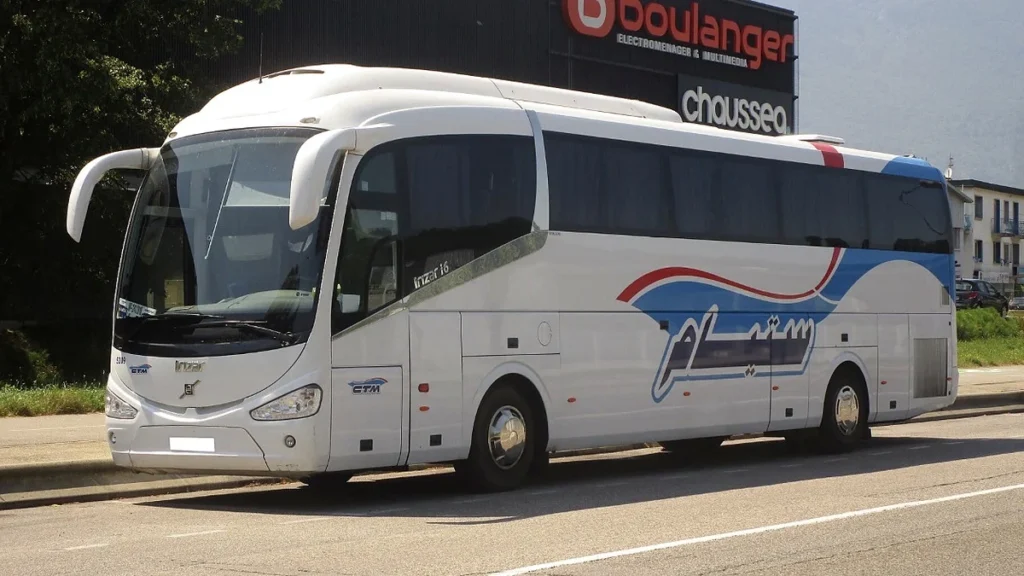 White CTM coach parked beside a road