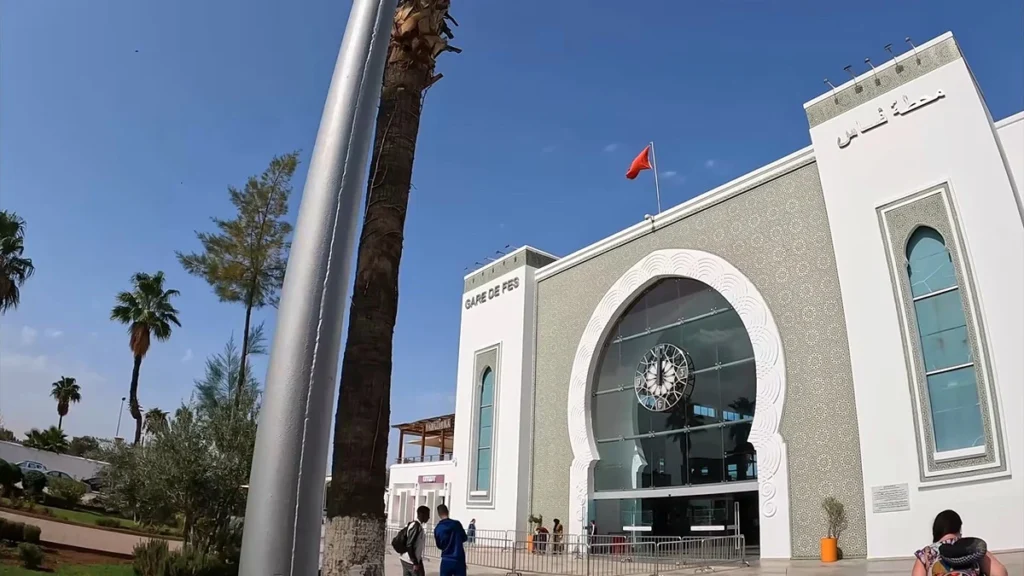Entrance to Fes railway station with its arched facade and clock