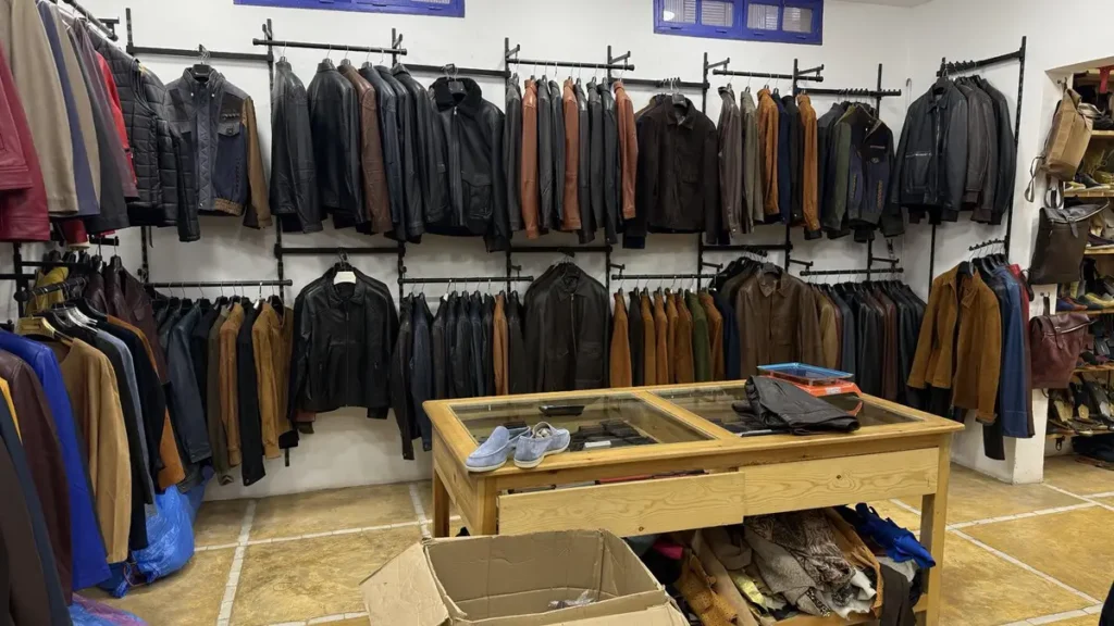Black and brown leather jackets hanging inside a Marrakech shop