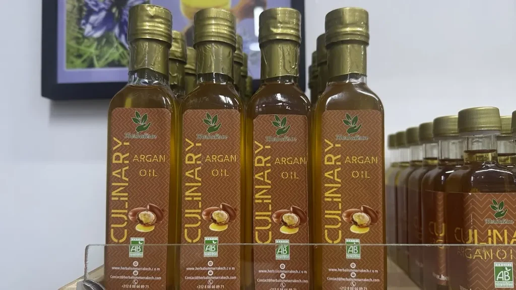 Bottles labeled culinary argan oil on a Marrakech shop shelf