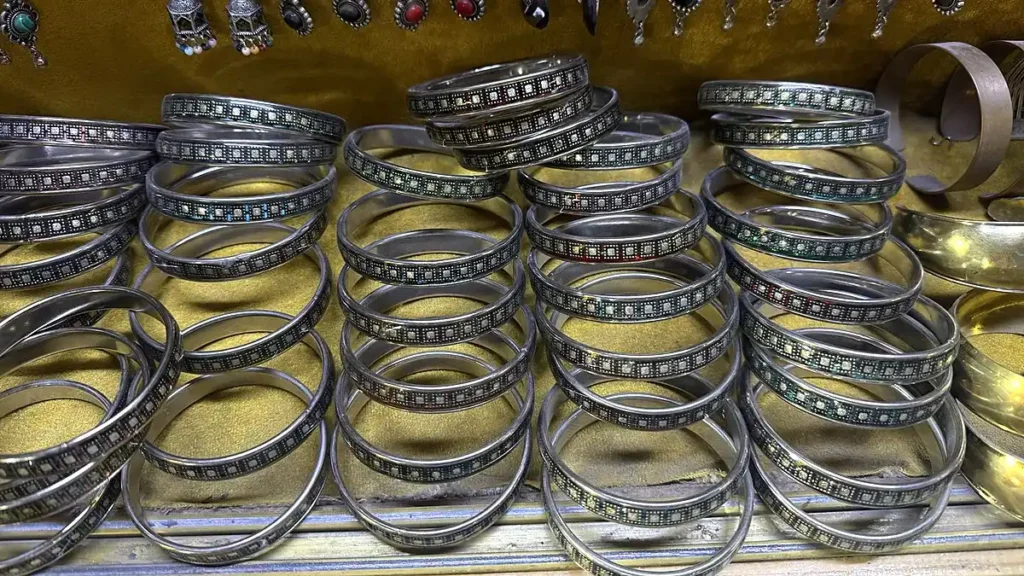 Rows of decorative metal bracelets with patterned bands in Marrakech