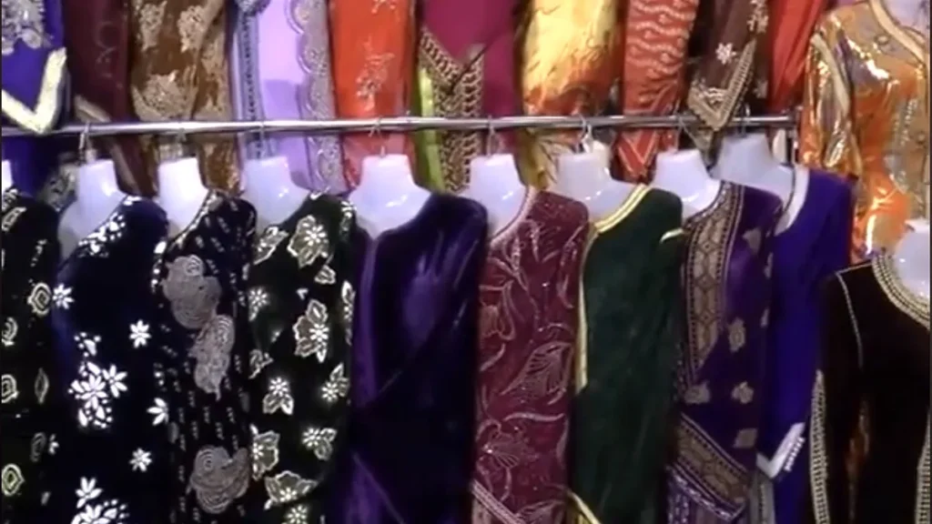 Black, purple, burgundy and green kaftans displayed on mannequins