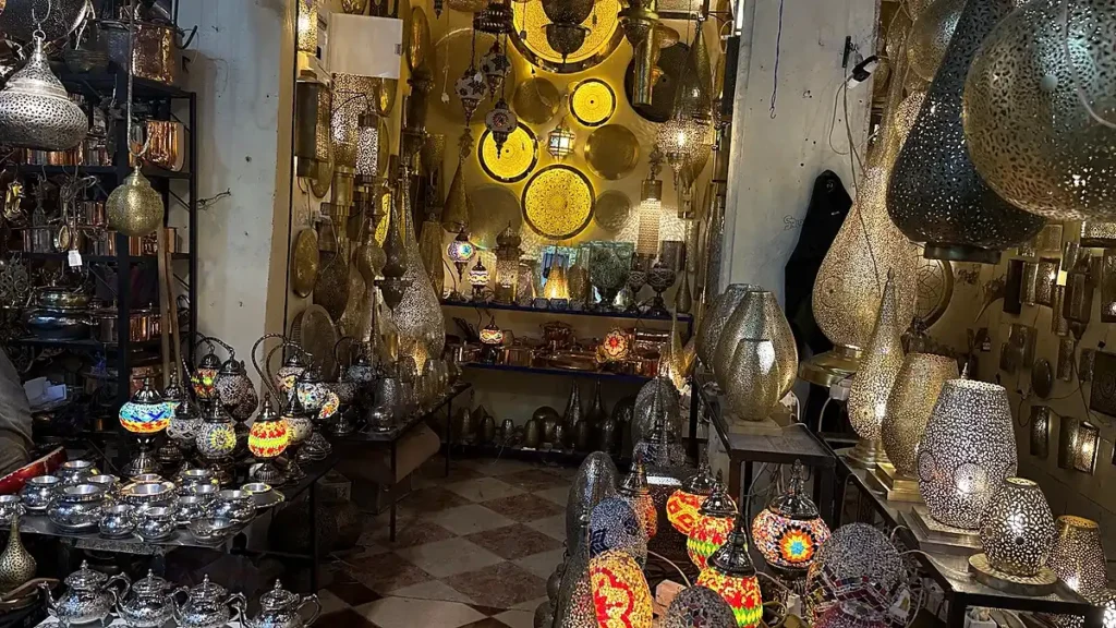 Marrakech shop displaying hanging lanterns, table lamps and metal crafts