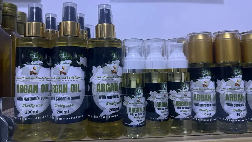 Bottles labeled argan oil with gardenia scent in different sizes