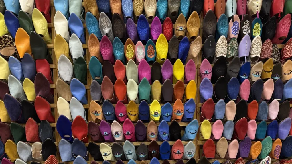 Colourful Moroccan babouches arranged on a shop wall in Marrakech