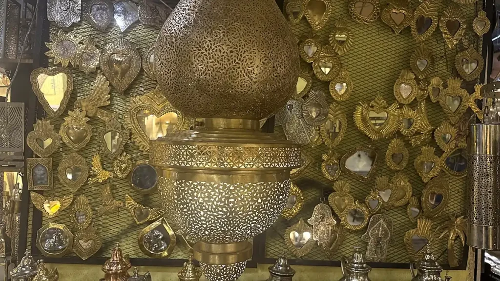 Close view of a pierced metal lantern with decorative floral openings