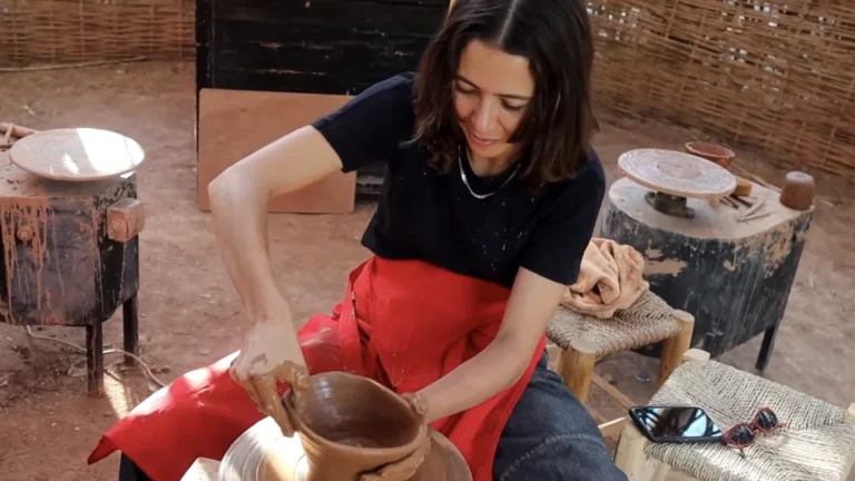 Visitor shaping a clay bowl during a pottery workshop in Marrakech