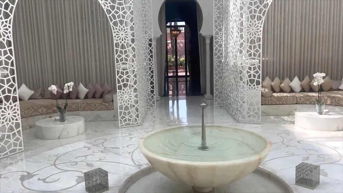 White lattice screens, cushioned seating and a marble fountain at the Royal Mansour Marrakech spa