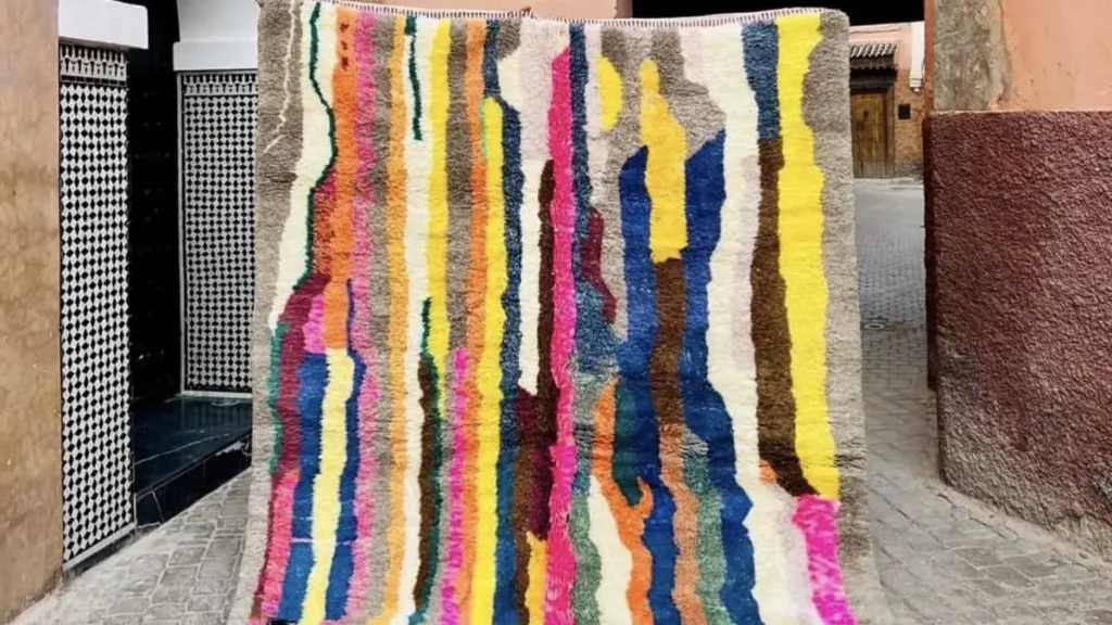 Brightly striped rug displayed outside a shop in Marrakech