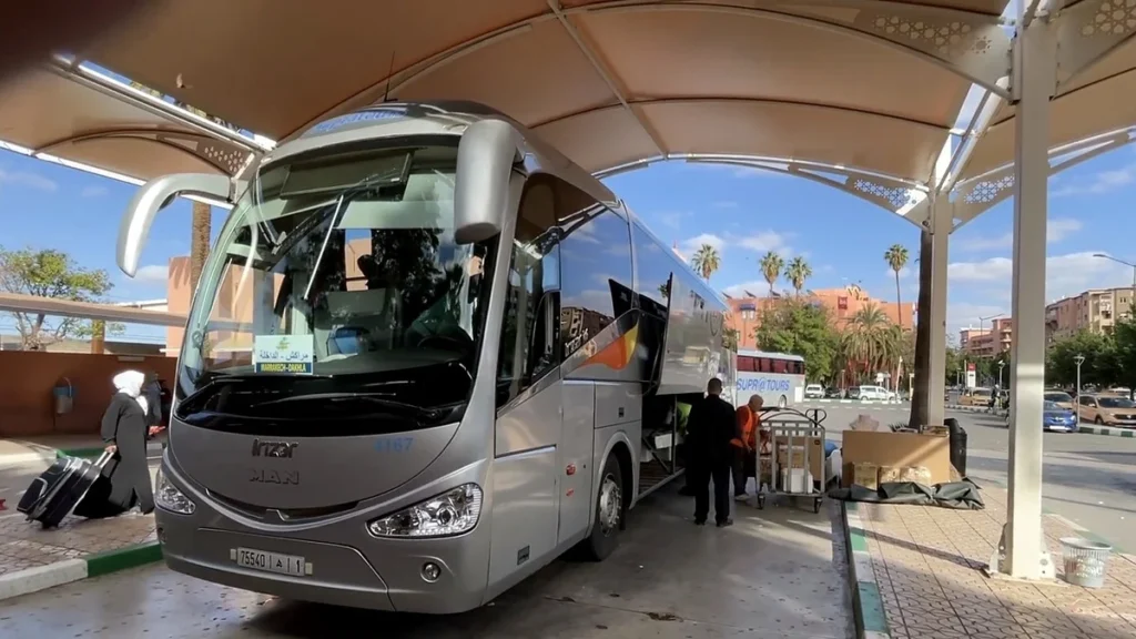 Coach at a Supratours terminal with an open luggage compartment and bags nearby