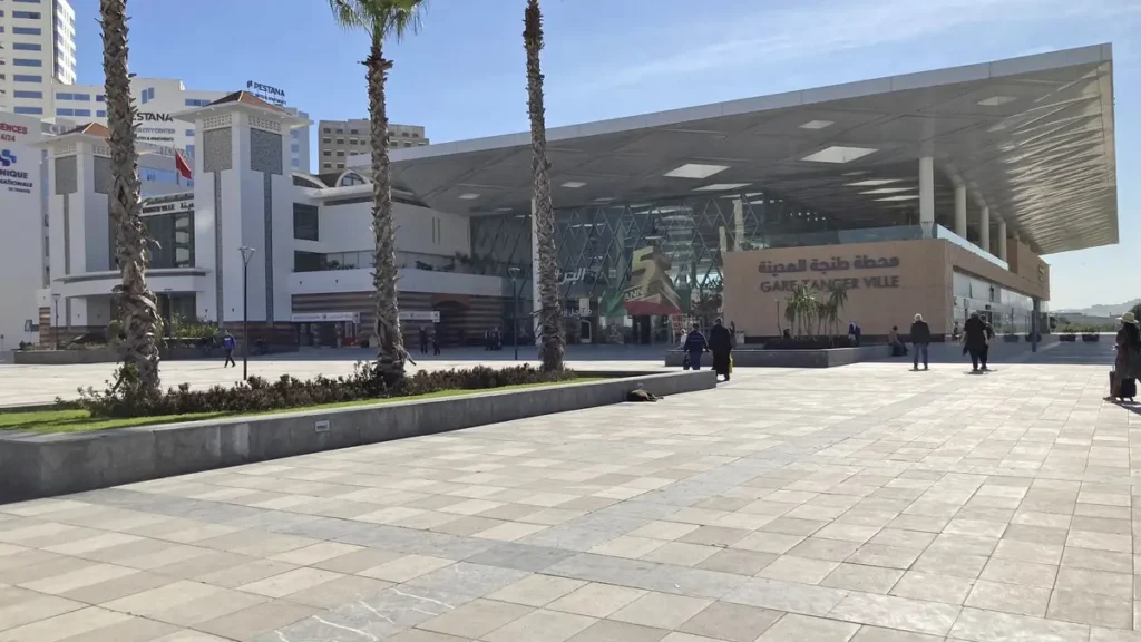 Tanger Ville railway station exterior with palm trees and a pedestrian forecourt